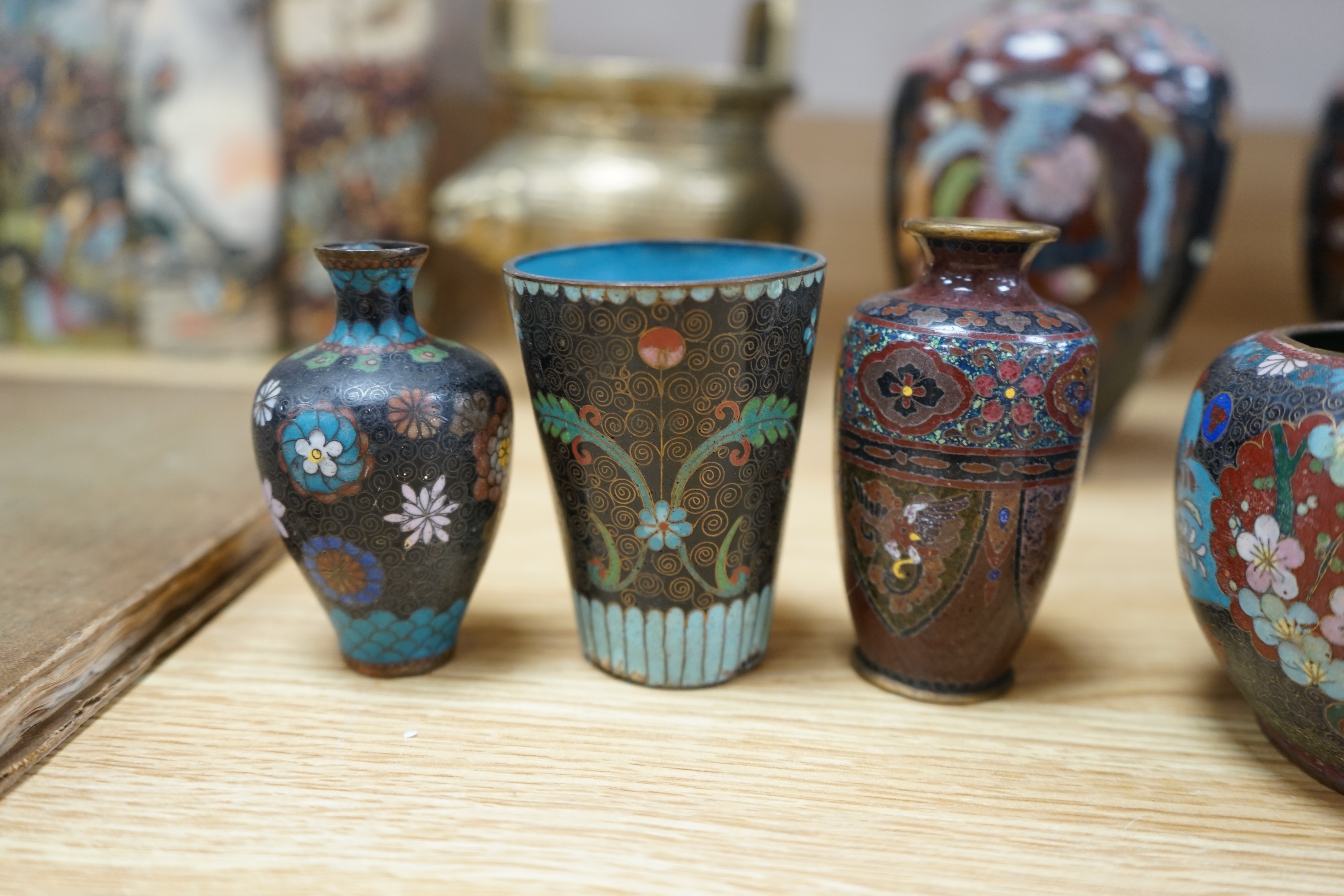 A large collection of Chinese and Japanese cloisonné vases and a brass twin handled censer, largest 31cm high. Condition - mostly poor to fair